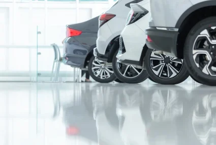 Cars For Sale, Automotive Industry, Cars Dealership Parking Lot. Rows of Brand New Vehicles Awaiting New Owners, on the epoxy floor in new car service